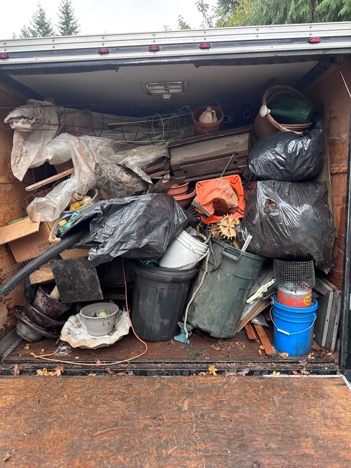 Trailer packed full of household junk and debris from a Central Oregon property cleanout